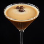 Classic espresso martini in a martini glass with three coffee beans as garnish