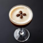Non-Alcoholic Espresso Martini in a martini glass with coffee bean garnish